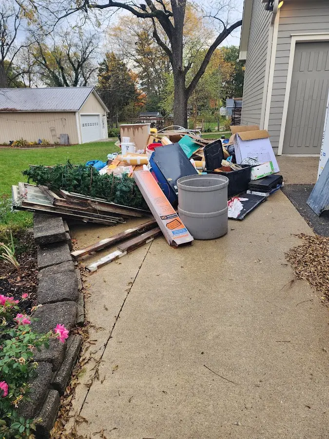 Dumpster being loaded with debris for 12 Yard Dumpster Rental in Orange Park